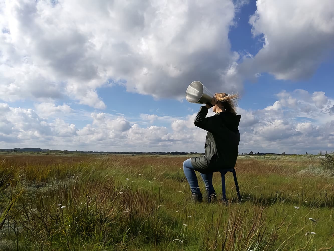 Sandra Boss listening in a field